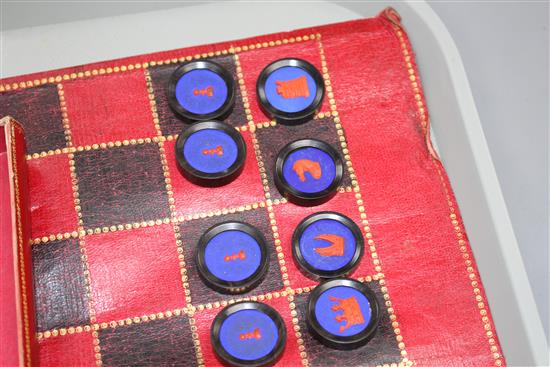 A 19th century Jaques Patent portable B.C.D. backgammon, chess and draughts board set, the gilt tooled red morocco cylinder holder